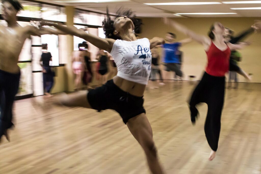 pexels-photo-12312-12312 Dynamic group dance class showcasing diverse techniques and spirited expressions.