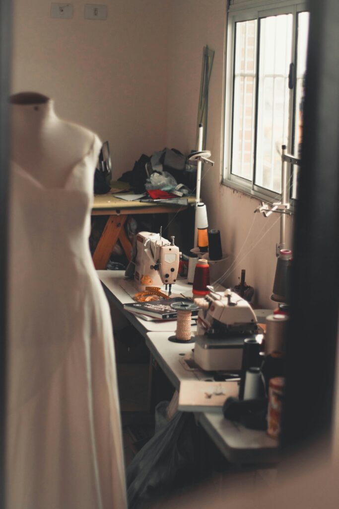 pexels-photo-2974116-2974116 A warm, inviting home sewing room with a dress form and sewing machines at work.