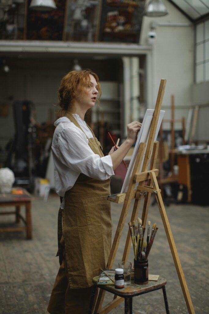 pexels-photo-3778203-3778203 A focused female artist paints on canvas in an art studio, showcasing creativity and skill.
